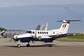 Beech B200 King Air, L/ZK452,  from 45 (Reserve) Squadron taxies past USAF static participants as the Belgian support C-130H takes off in the background.