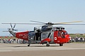 Westland Sea King HU.5, XV699/823/PW23, from the Royal Navys HMS Gannet Search and Rescue Flight departing on a task late in the afternoon.