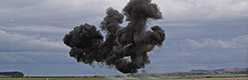 A simulated bomb explosion during the GR.4 Role Demo with one of the aircaft orbiting to await further direction from the troops in contact