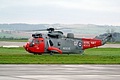 Seen here settling into the grass on arriving from its home at Prestwick is HMS Gannet SAR Flight Sea King HU.5 XZ920/07