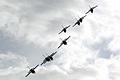 Silhouetted against the clouds the different take-off elements of the Patrouille de France pull into formation for their display