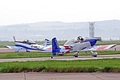 This over-the-shoulder view into the cockpit highlights the small size of the Vans RV8 of the RV8tors pair as they taxi out to display