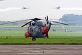 The HMS Gannet SAR Flight Sea King HU.5 provides a spot for one of the crew to watch the RV8tors in a low-level opposition pass