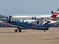 Rolls-Royce operated Spitfire PR.XIX taxies back in with a line-up of heavies in the background