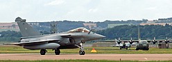 Rafale M '38' with Austrian C-130K beyond and RAF Solo Display Typhoon taxying out in the background