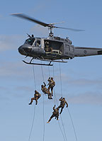 Soldiers fast roping from the UH-1H