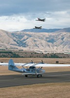 PBY-5A Catalina with P-40 Kittyhawks overhead