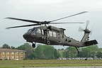 A UH-60M is moving from parking area closer to the runway for take off