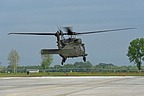 The UH-60M, serial #11-20398, is in hovering waiting to reach the take off point on the runway