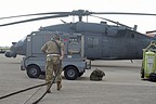 The ground personnel removes the power cable away from the HH-60G Pave Hawk