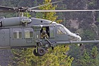 Flight engineer and gunner, seated on opposite side of the helicopter, assist pilots in identifying any kind of obstacle during approach operation