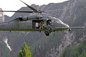 Flight engineer on board the HH-60G operating the hoist capable of lifting a 270 kilograms load (600 pound) from a hover height of 60.7 meters (200 feet)
