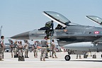 Turkish pilot climbing into the cockpit of his F-16