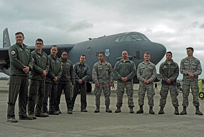 B-52 Flight crew (aircraft commander, pilot, radar navigator, navigator and electronic warfare officer) and ground crew pose in front of the aircraft.