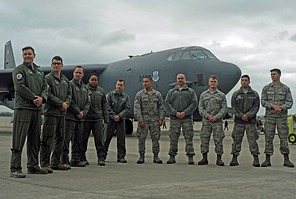 B-52 Flight crew (aircraft commander, pilot, radar navigator, navigator and electronic warfare officer) and ground crew pose in front of the aircraft.