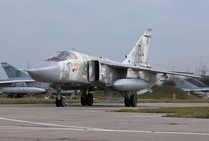 The overhauled Su-24M 41 White returning, passing a number of stored Su-24Ms