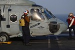 HS-5 squadron members washing the window and final inspections on the Seahawk