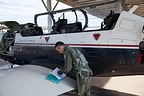 Major Spiros Batzios, the Greek Senior National Representative (SNR), checking the tech logs before the flight