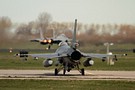 RNLAF F-16AM with USAF F-15C taking off in the background