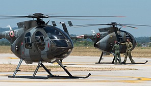 TH-500 72-31 preparing for take-off, with in the background student of instructor are performing pre-flight checks on 72-36