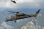 The pair of AH-129D Mangustas fly over the action area to protect the soldiers operating on the ground