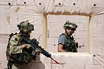 Airmobile infantry soldier on watch, while special forces secure the building
