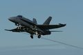 Swiss F-18C Hornet retracting its gear after take-off.