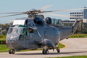 The loadmaster waiving out of the CH-124A Sea King 12405