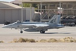 US Navy F/A-18E Super Hornet passing the F-22 Raptors, which unfortunately did not take part