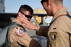 First Lt. Eric Tise, an F-16 Fighting Falcon pilot from the 555th Expeditionary Fighter Squadron, places a patch on Lt. Col. Vince O’Connor’s uniform at Bagram Airfield, Afghanistan, May 19, 2017. The patch was made to commemorate O’Connor surpassing the 2,000-hour mark for flying. (U.S. Air Force photo by Staff Sgt. Benjamin Gonsier)