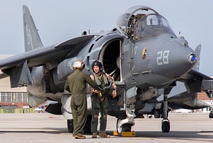 Crew chief and pilot shake hands after a safe return from a training mission